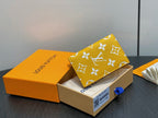 Small bag with yellow monogram print foldover flap, corner detail