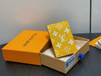Small bag with yellow monogram foldover flap in open view