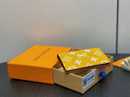 Small bag with yellow monogram print and brown edge, front flap upright