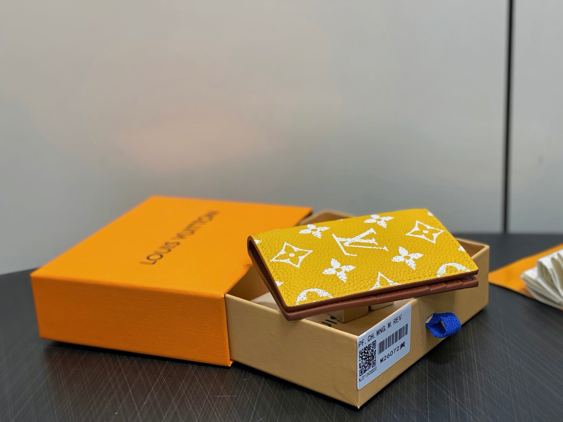 Small bag with yellow monogram print and brown edge, front flap upright