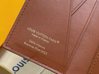 Brown leather small bag with Louis Vuitton Paris text, close-up