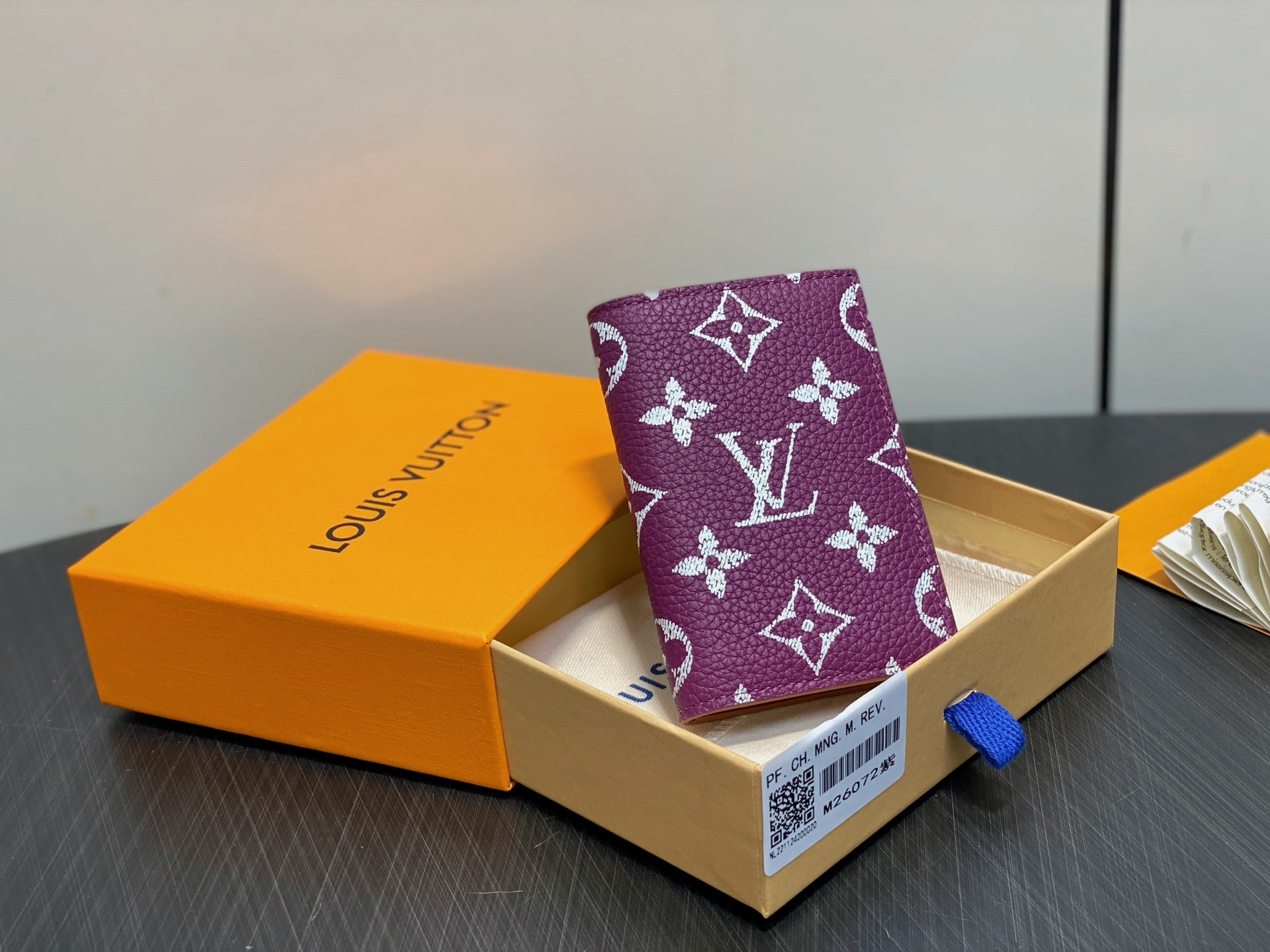 Purple small bag with white monogram flowers, open gift box packaging