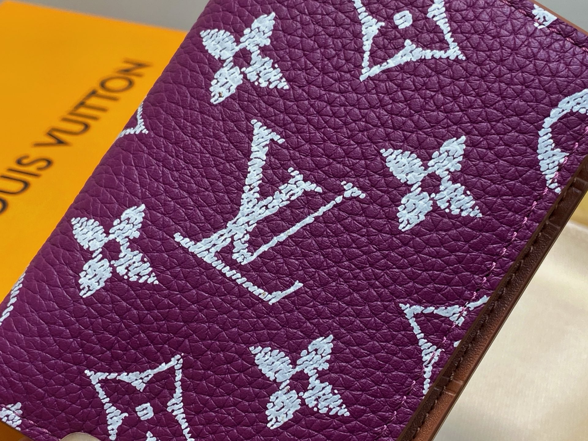 Purple leather small bag with white LV monogram flowers, close-up
