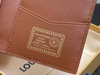 Brown mini wallet interior panel with gold printed label and stitching, close-up