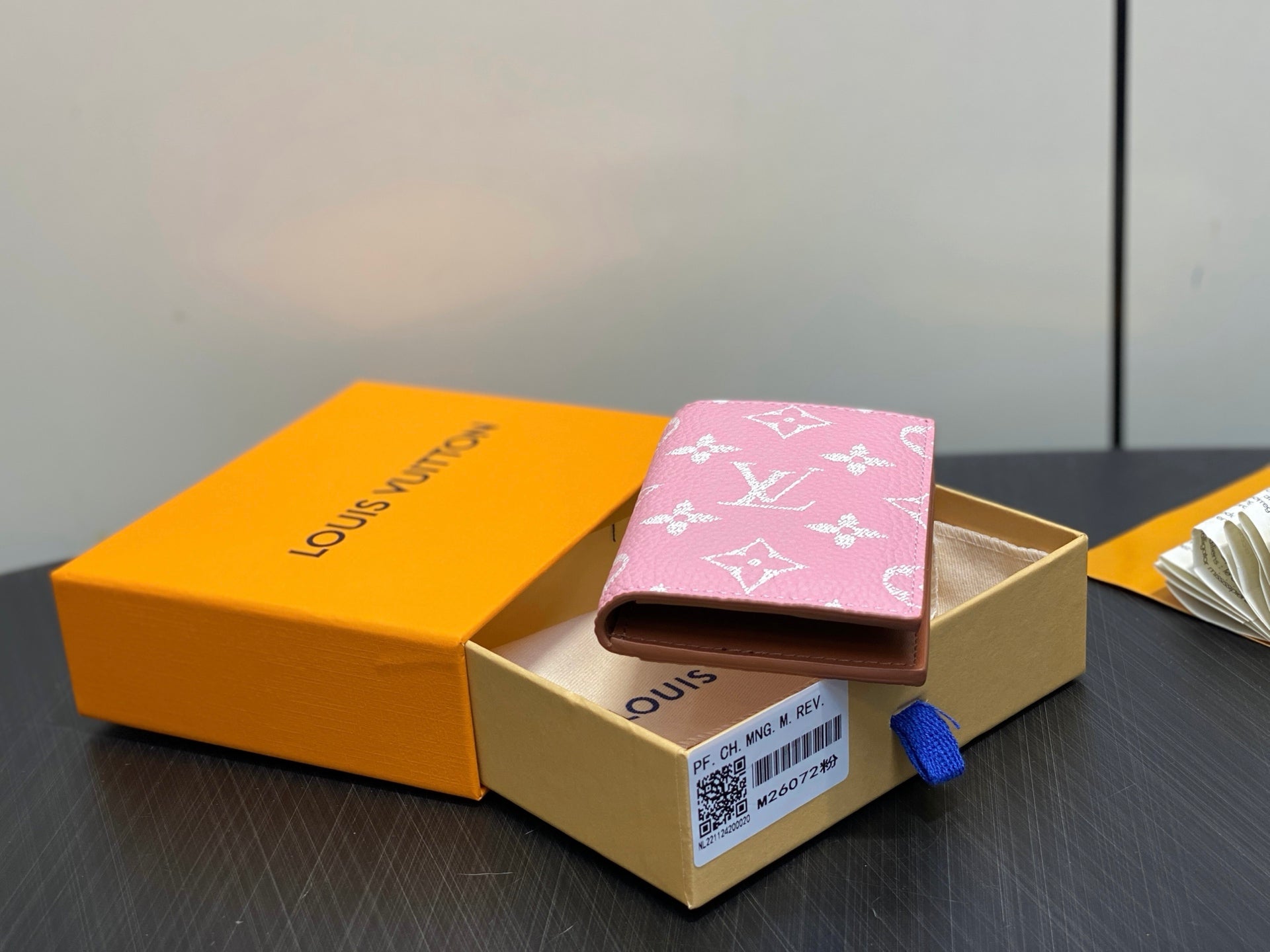 Pink monogram mini wallet angled in gift box