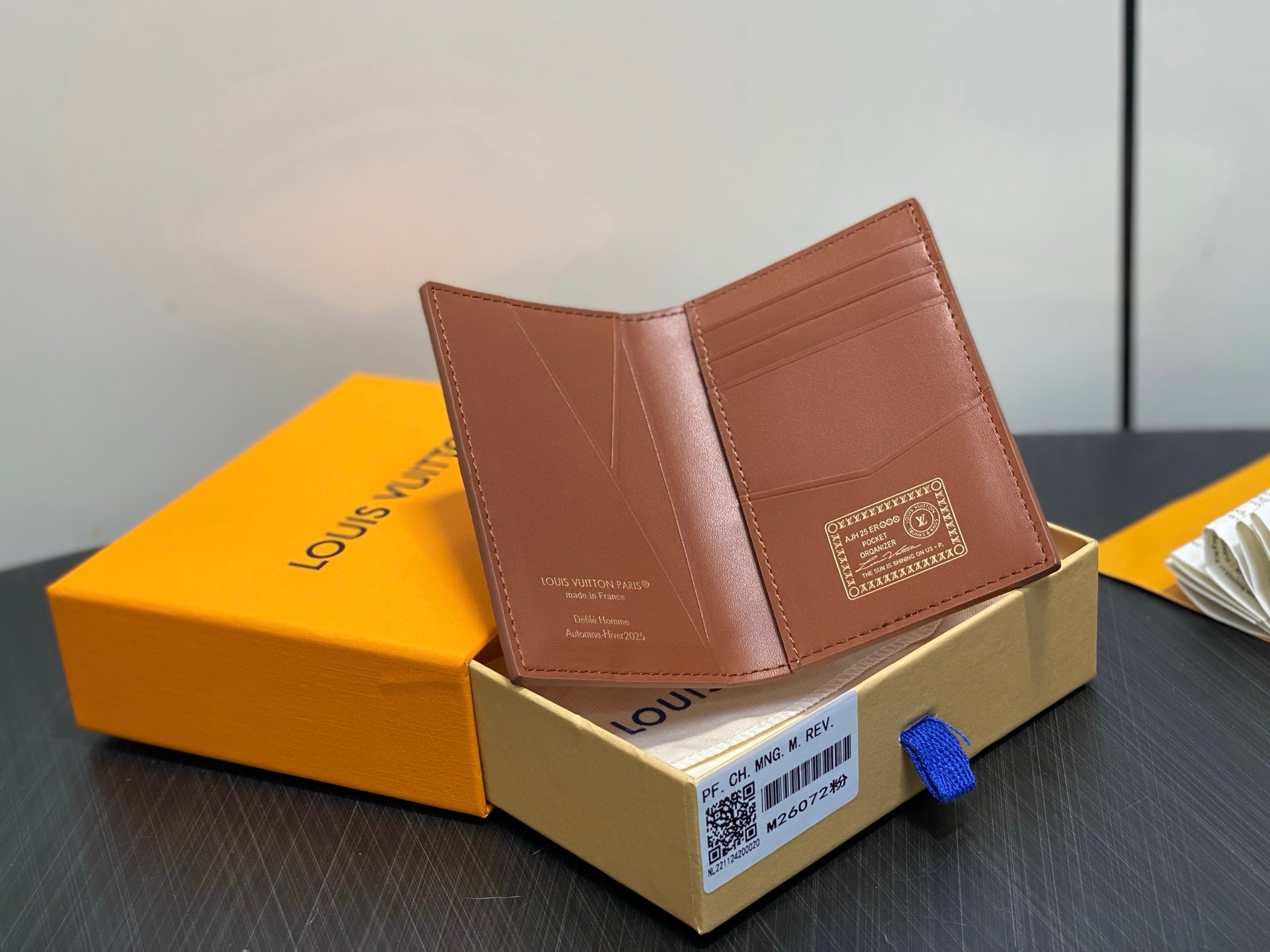 Brown leather mini wallet open with card slots, in gift box