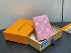 Pink monogram mini wallet in gift box with blue pull tab