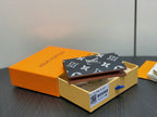 Small wallet with dark navy monogram exterior and dark interior, open