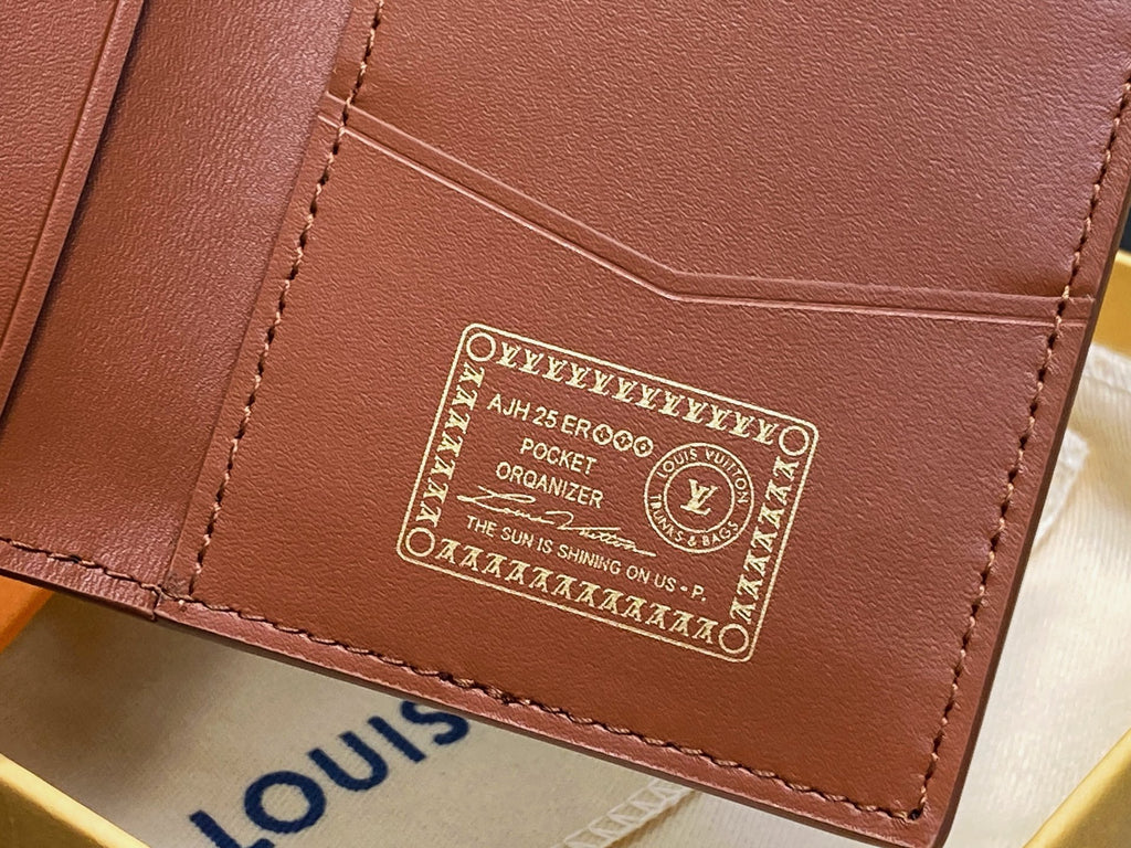 Small brown leather wallet with embossed logo patch and stitched edges
