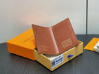 Small brown leather wallet with logo patch, open with card slots