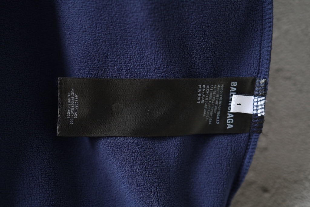 Navy jacket interior label tag near collar seam