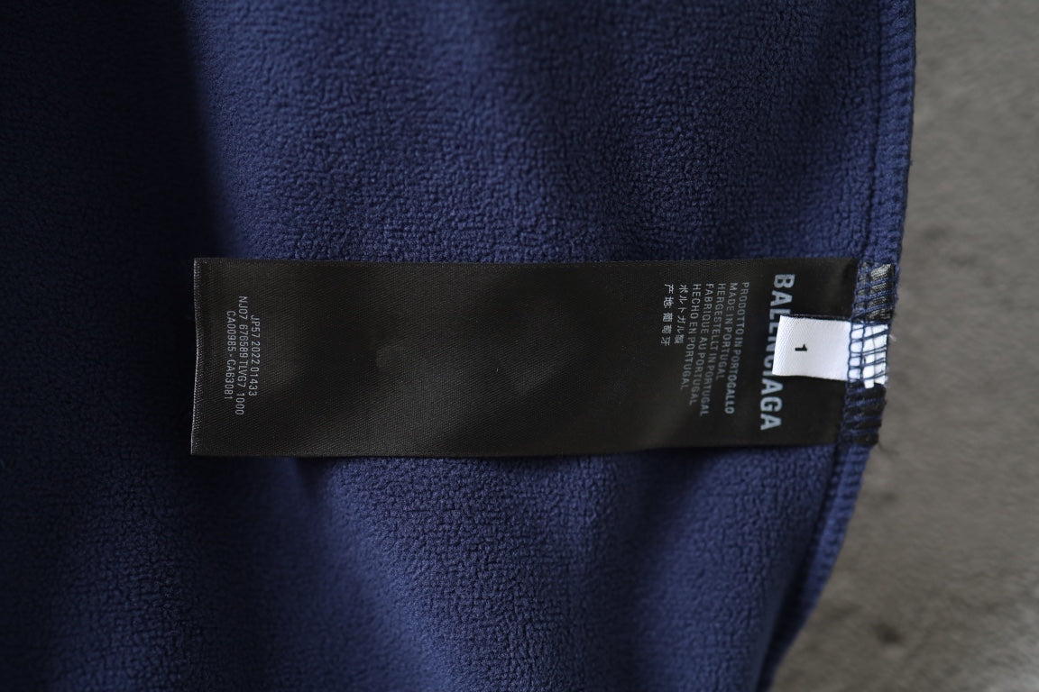 Navy jacket interior label tag near collar seam