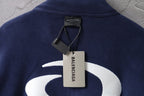 Navy jacket with white Balenciaga graphic and hanging brand tags at collar