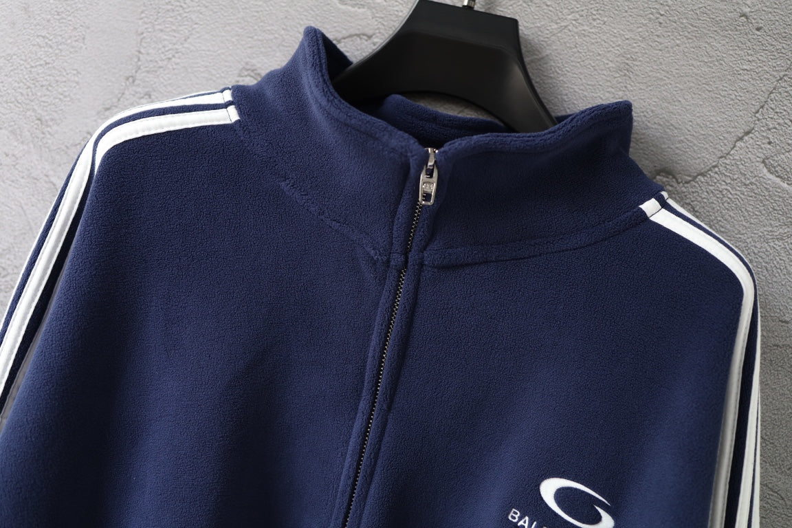 Navy zip-up jacket with high stand collar and striped shoulder accents