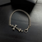 Silver-tone chain bracelet featuring a cross charm and ring clasp