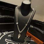 Silver-tone chain necklace with dagger pendant and fleur de lis charm