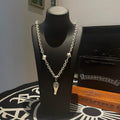 Silver-tone chain necklace with fleur de lis and dagger charms
