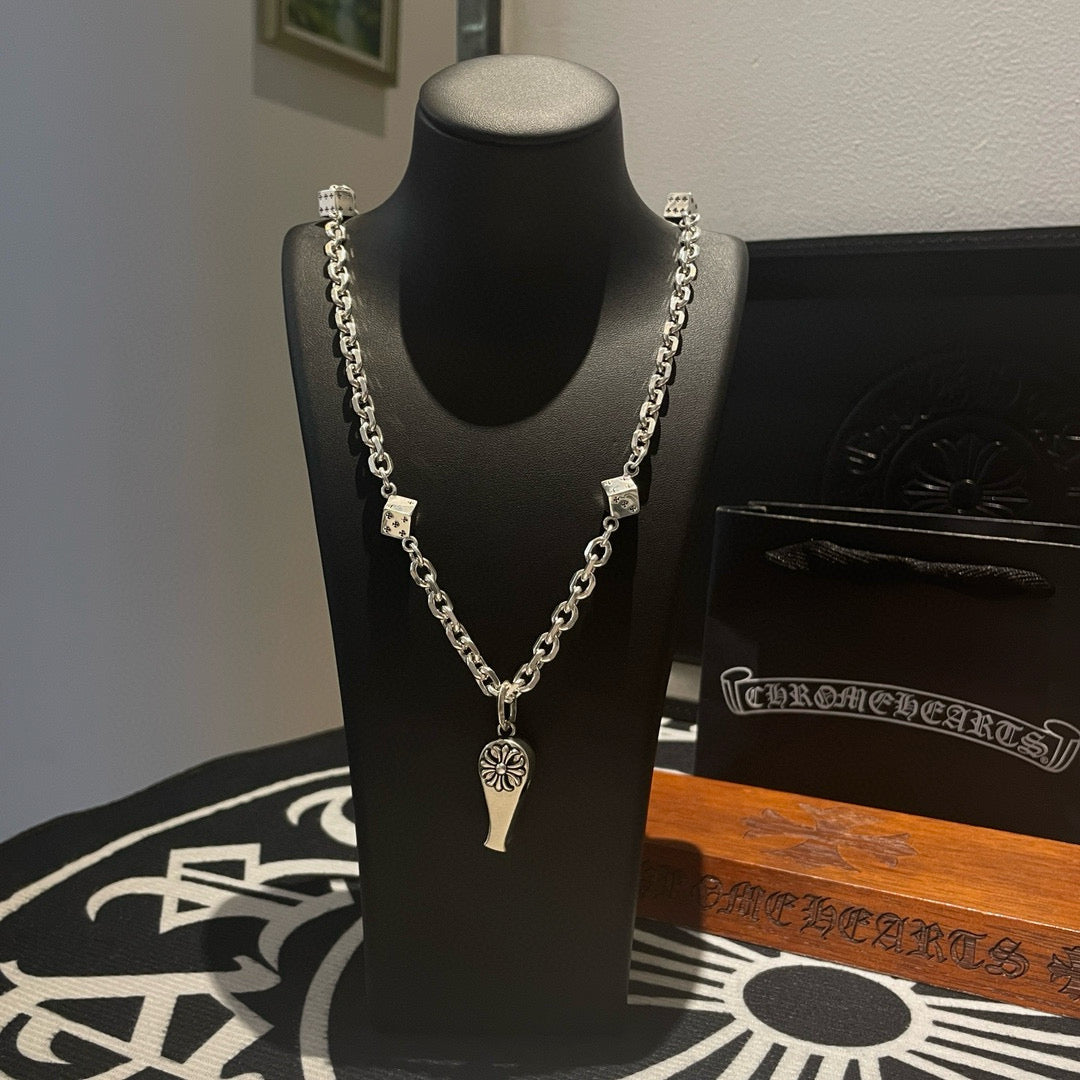 Silver-tone chain necklace with fleur de lis and dagger charms