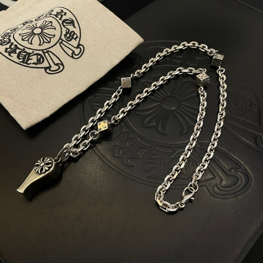 Silver-tone chain necklace with fleur de lis and dagger charms with cloth pouch