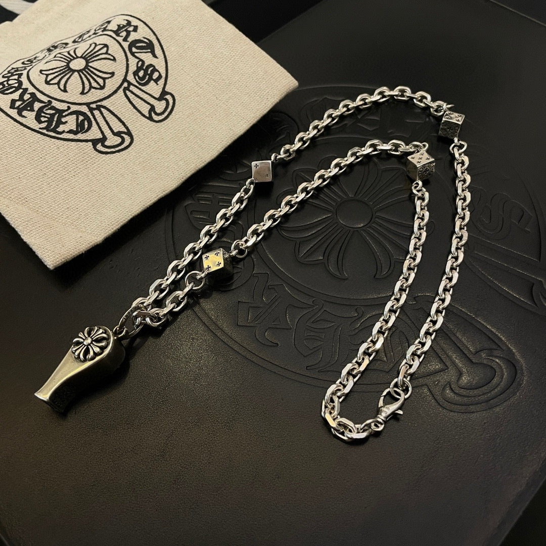 Silver-tone chain necklace with fleur de lis and dagger charms with cloth pouch