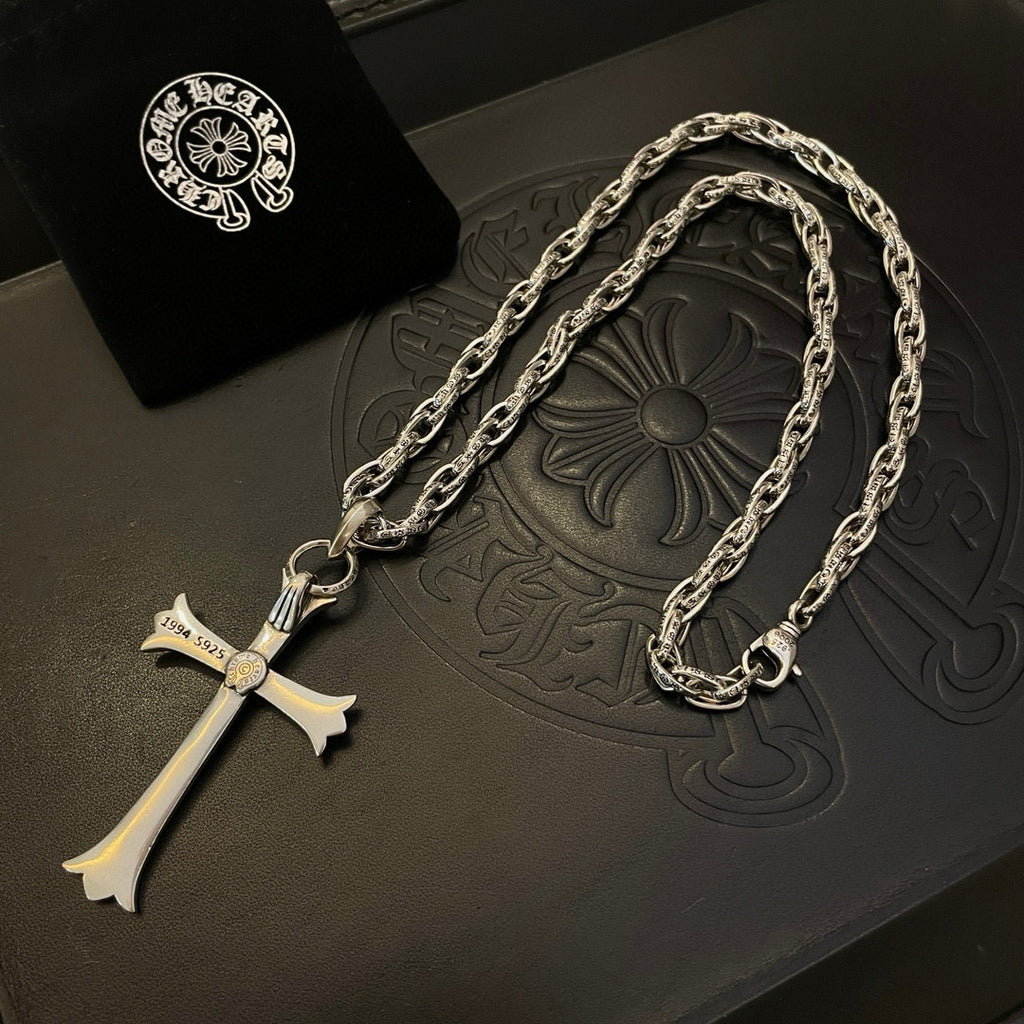 Silver-tone cross pendant necklace with round emblem on chain