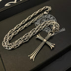 Silver-tone cross pendant necklace with stacked links, shown close-up