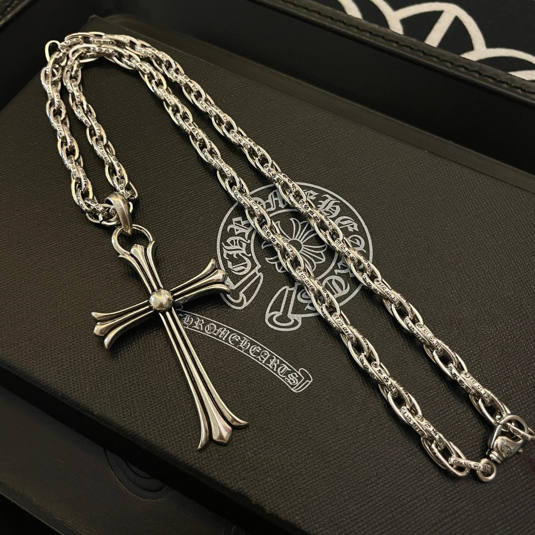 Silver-tone cross pendant necklace with chunky chain on gift box