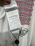 Long-sleeve graphic shirt neckline and size/clearance tag on the front