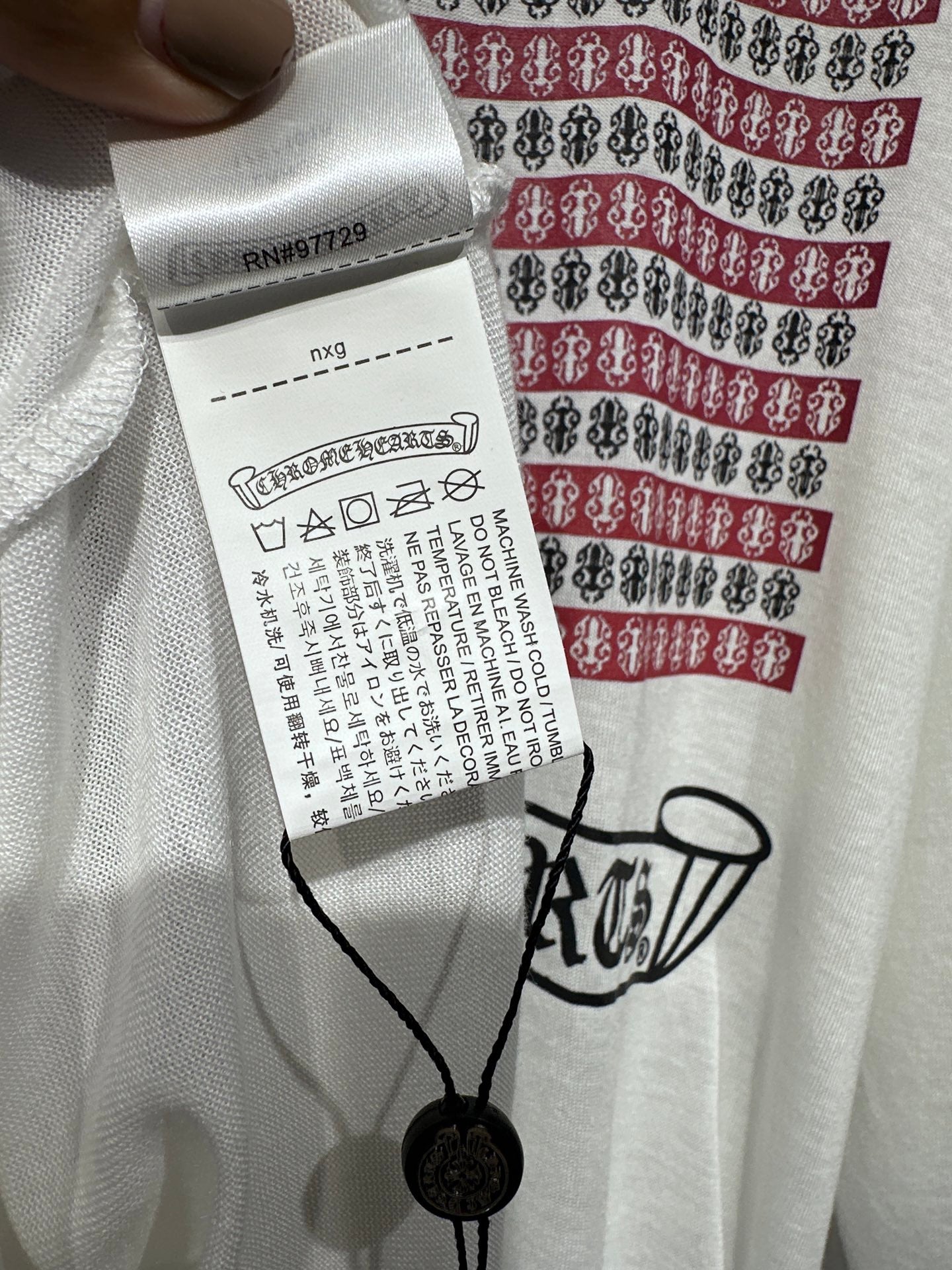 Long-sleeve graphic shirt neckline and size/clearance tag on the front
