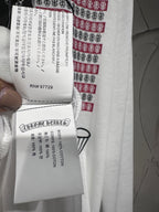 Long-sleeve graphic shirt fabric tag with printed sizing and care details on the sleeve