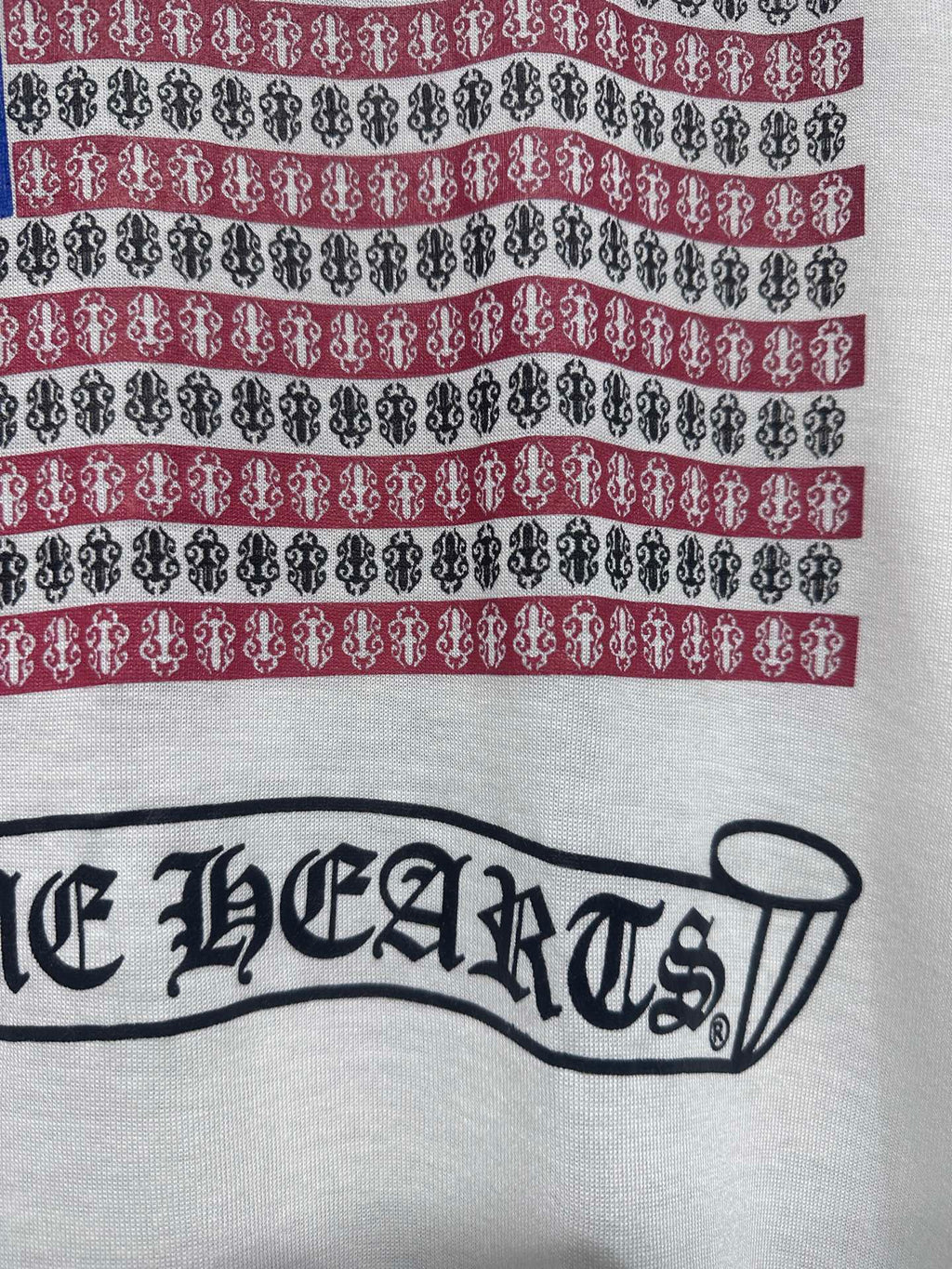 Long-sleeve graphic shirt, front logo text across chest with red and blue stripe bands