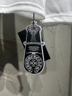White long-sleeve shirt hanging with black tag and white emblem graphic.