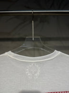 White long-sleeve shirt front neckline with small circular chest logo.