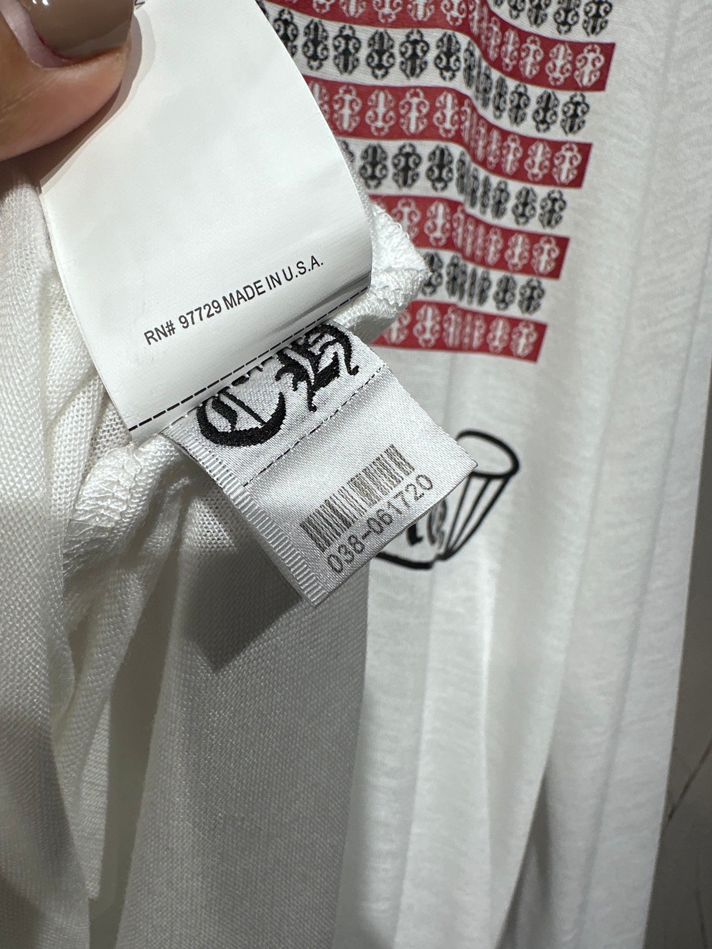 Long-sleeve graphic shirt neck tag reading "MADE IN U.S.A." with barcode sticker