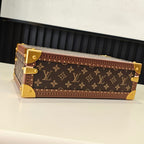 Monogram travel bag with gold-tone corners and front clasp, side view