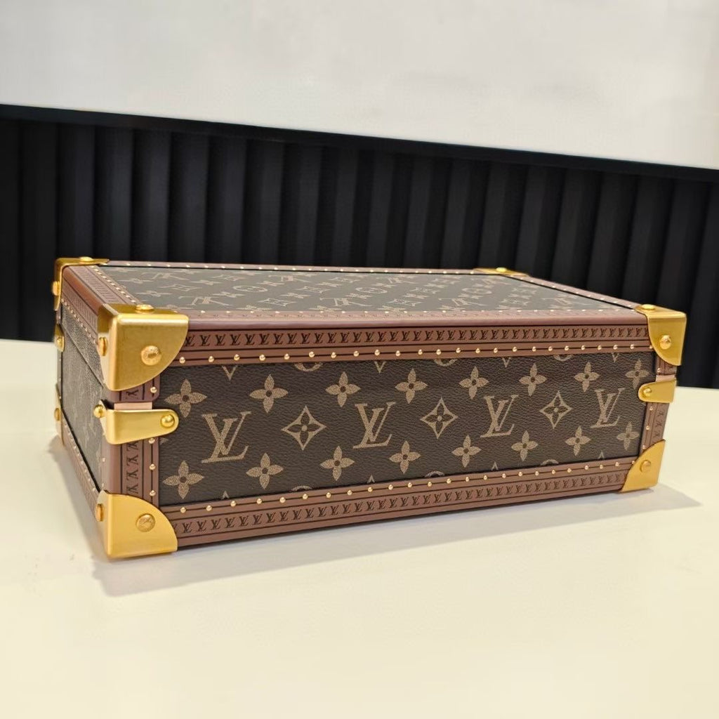 Louis Vuitton monogram trunk bag with gold trim and hardware, side angle, closed