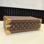 Louis Vuitton monogram trunk bag with gold trim and hardware, side angle, closed