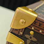 Louis Vuitton monogram bag strap detail with gold corner hardware and studs