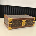 Louis Vuitton monogram trunk bag with gold corner feet and patterned top, closed