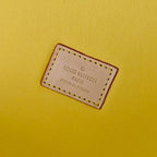 Louis Vuitton Paris leather label on yellow lining, stitched edge close-up