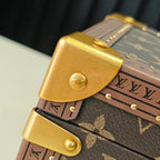 Louis Vuitton monogram trunk bag close-up of gold corner clasp hinge detail