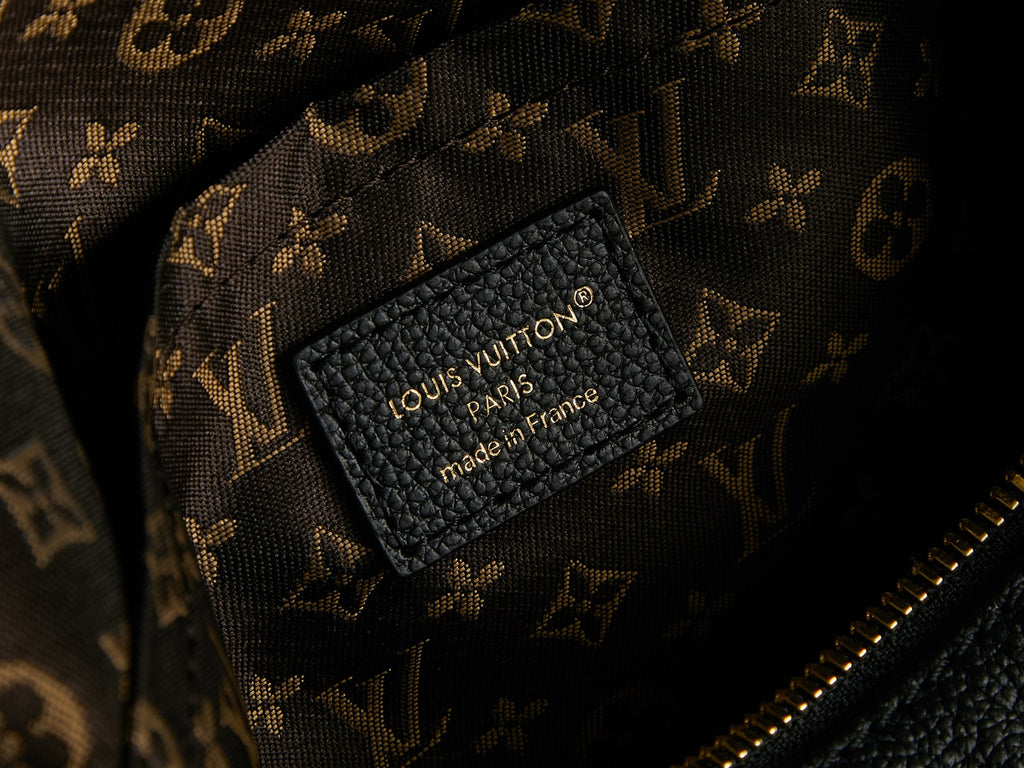 Louis Vuitton made in France label on black lining inside monogram canvas bag.