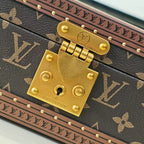 Louis Vuitton monogram trunk close-up of gold clasp and lock plate