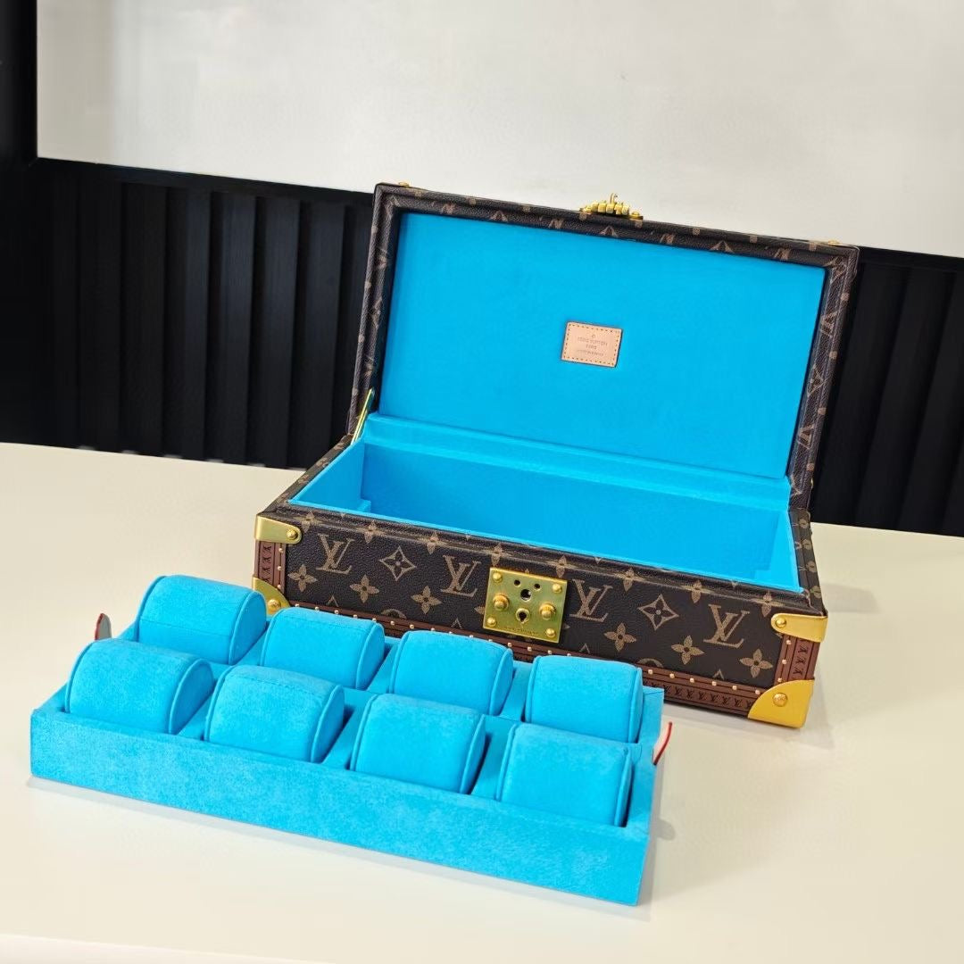 Louis Vuitton monogram trunk open, showing blue organizer insert and gold latch hardware