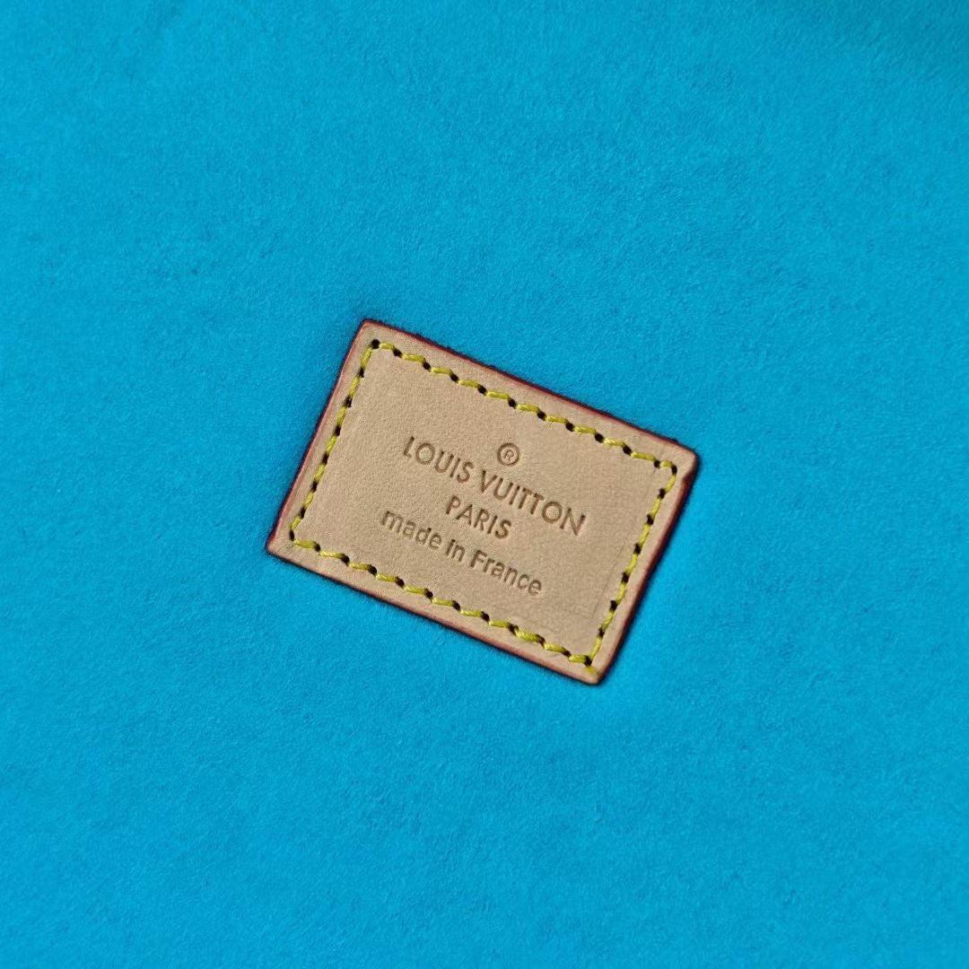 Louis Vuitton label on blue lining reading “Paris” and “Made in France”