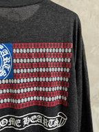 Long-sleeve T-shirt sleeve detail with patterned stripes and small decorative text