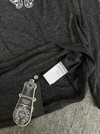 Long-sleeve T-shirt with hang tag labels on dark heather gray fabric fold