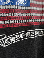 Long dark pants with bold white brand graphic and patterned waistband