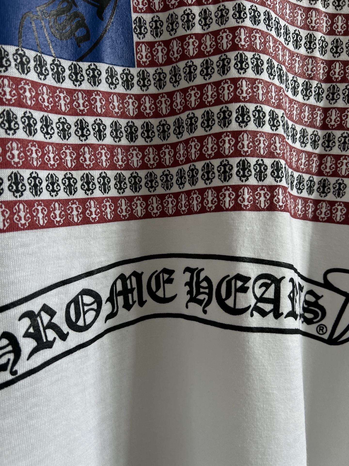 Close-up of front graphic ribbon with ornate script-style logo and dark outline.