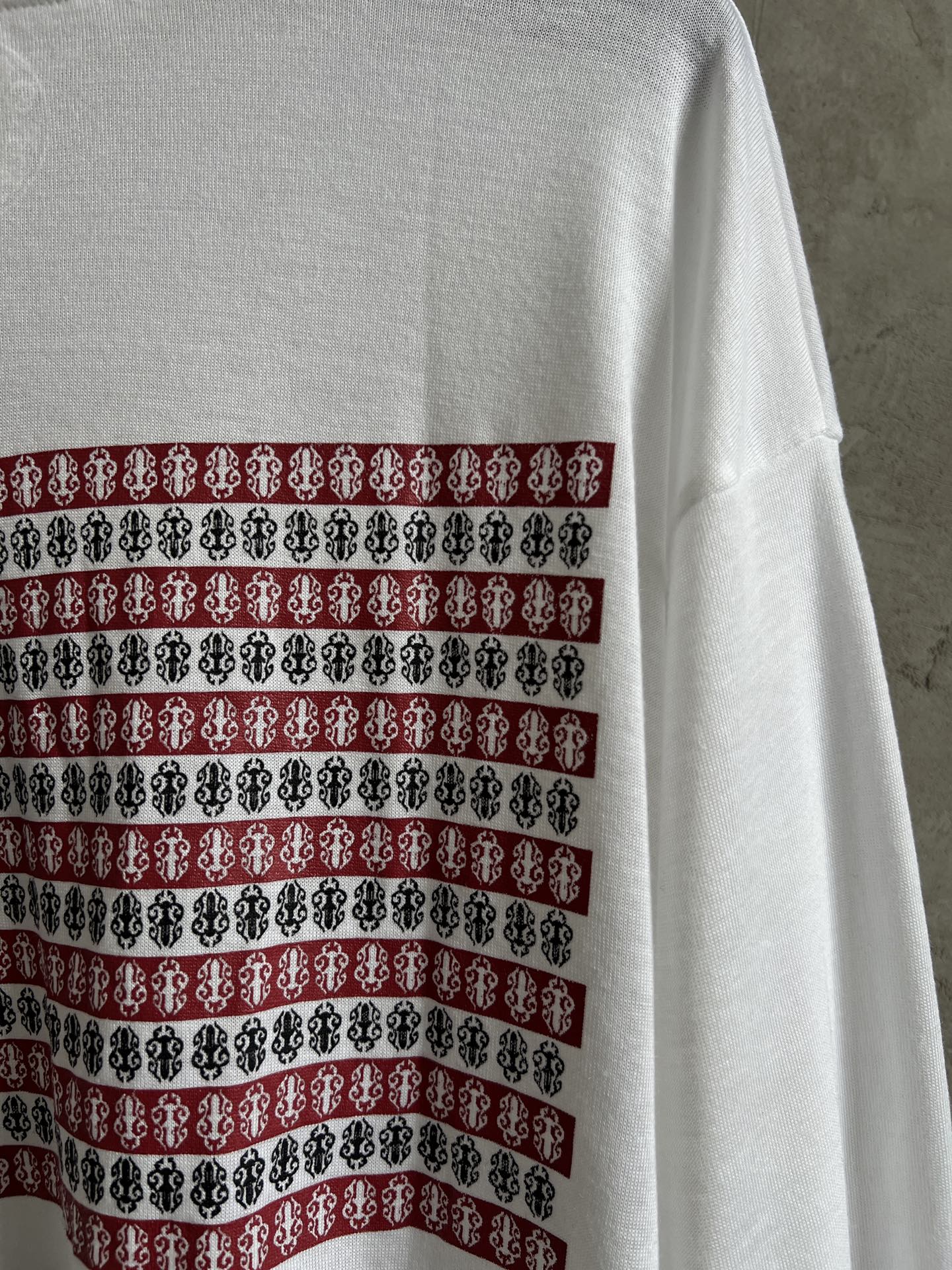 Back of white long-sleeve shirt with horizontal striped graphic band across upper back.